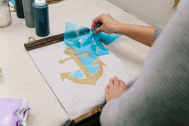 After the color has dried, the stencil is peeled off to reveal a perfectly painted piece.